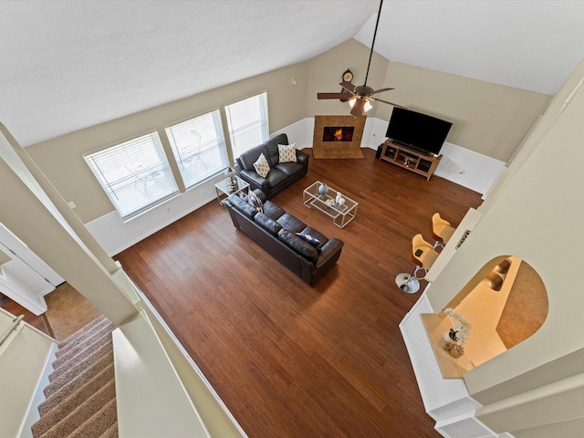 3139 Prairiestone Trail Ln, Katy, TX 77450 - living area with a ceiling fan, wood finished floors, stairs, a fireplace, and high vaulted ceiling
