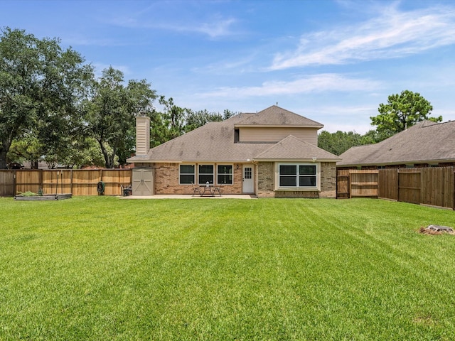 3139 Prairiestone Trail Ln, Katy, TX 77450 - rear view of house featuring a fenced backyard, brick siding, a chimney, and a patio