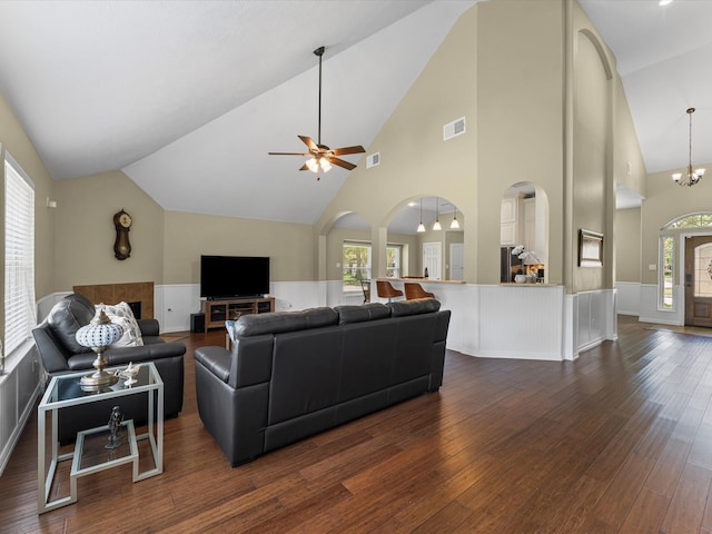 3139 Prairiestone Trail Ln, Katy, TX 77450 - living room featuring dark wood finished floors, a ceiling fan, arched walkways, high vaulted ceiling, and a chandelier