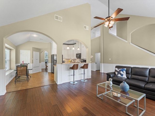 3139 Prairiestone Trail Ln, Katy, TX 77450 - living area with ceiling fan, arched walkways, dark wood-type flooring, and high vaulted ceiling