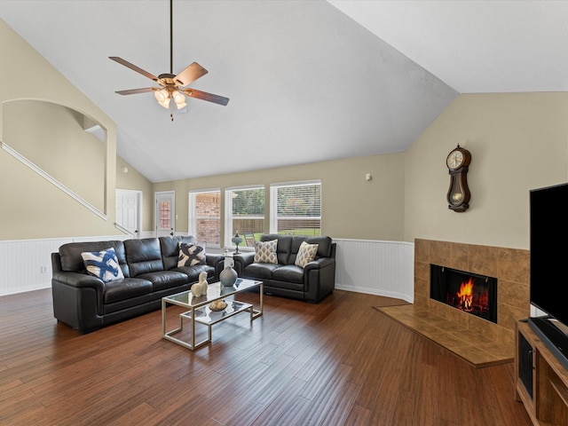 3139 Prairiestone Trail Ln, Katy, TX 77450 - living room featuring a wainscoted wall, lofted ceiling, wood finished floors, a ceiling fan, and a tile fireplace