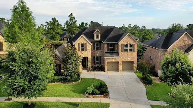 207 Fox Squirrel Ct, Pinehurst, TX 77362 - view of front of home featuring an attached garage, concrete driveway, brick siding, and a front lawn