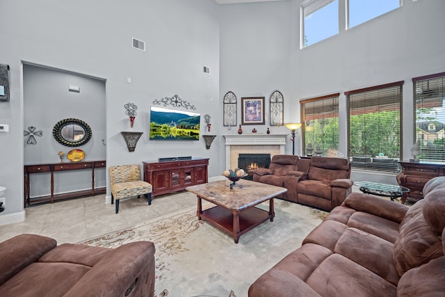 207 Fox Squirrel Ct, Pinehurst, TX 77362 - living area featuring a high ceiling and a lit fireplace