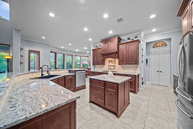 207 Fox Squirrel Ct, Pinehurst, TX 77362 - kitchen featuring crown molding, stainless steel appliances, decorative backsplash, recessed lighting, and a spacious island