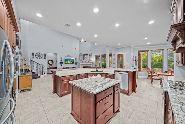 207 Fox Squirrel Ct, Pinehurst, TX 77362 - kitchen with stainless steel appliances, a spacious island, open floor plan, recessed lighting, and crown molding