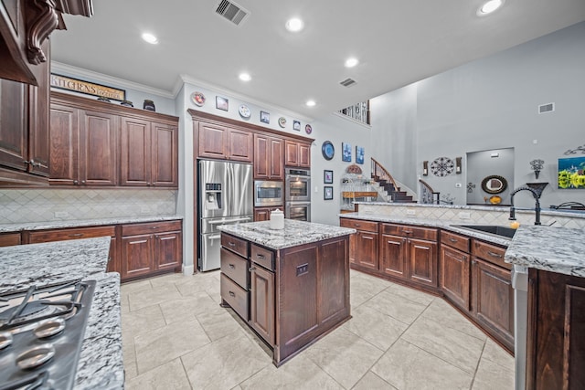 207 Fox Squirrel Ct, Pinehurst, TX 77362 - kitchen with stainless steel appliances, a center island, backsplash, ornamental molding, and recessed lighting