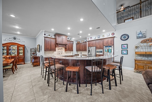 207 Fox Squirrel Ct, Pinehurst, TX 77362 - kitchen with stainless steel appliances, crown molding, tasteful backsplash, light stone counters, and a breakfast bar