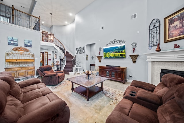 207 Fox Squirrel Ct, Pinehurst, TX 77362 - tiled living area with a towering ceiling, stairway, a fireplace, and recessed lighting