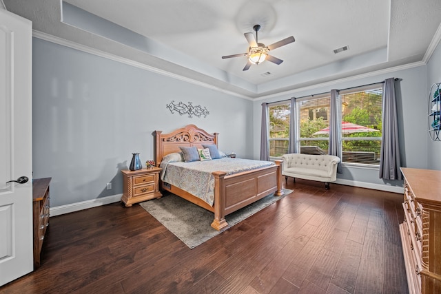 207 Fox Squirrel Ct, Pinehurst, TX 77362 - bedroom with a raised ceiling, dark wood-style floors, ceiling fan, and ornamental molding