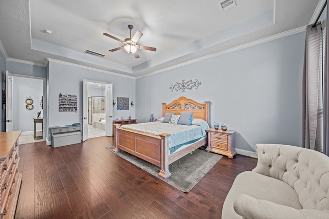 207 Fox Squirrel Ct, Pinehurst, TX 77362 - bedroom featuring a raised ceiling, dark wood-style floors, ensuite bathroom, ceiling fan, and crown molding