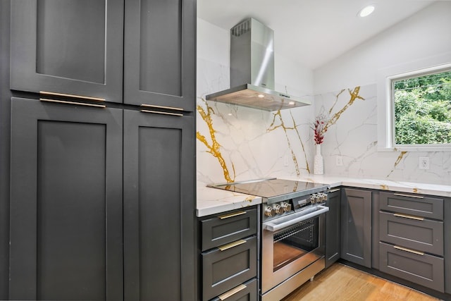 4543 Warm Springs Rd, Houston, TX 77035 - kitchen with stainless steel electric range, wall chimney range hood, decorative backsplash, gray cabinets, and light stone counters