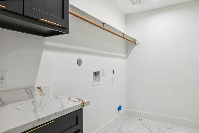 4543 Warm Springs Rd, Houston, TX 77035 - laundry area featuring hookup for an electric dryer, light marble finish floors, hookup for a washing machine, and cabinet space