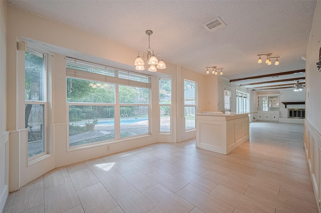 5318 Foresthaven Dr, Houston, TX 77066 - unfurnished dining area with a textured ceiling, a chandelier, healthy amount of natural light, and ceiling fan