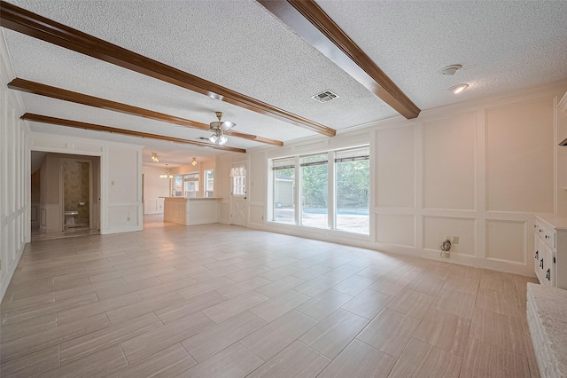 5318 Foresthaven Dr, Houston, TX 77066 - unfurnished living room with a decorative wall, a textured ceiling, beamed ceiling, and ceiling fan