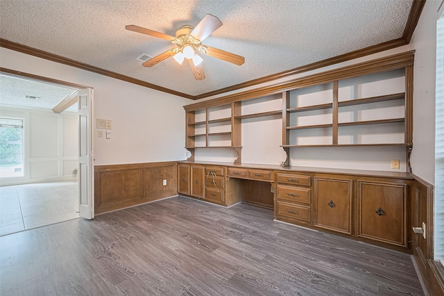 5318 Foresthaven Dr, Houston, TX 77066 - unfurnished office with built in study area, a textured ceiling, dark wood-style floors, a ceiling fan, and ornamental molding