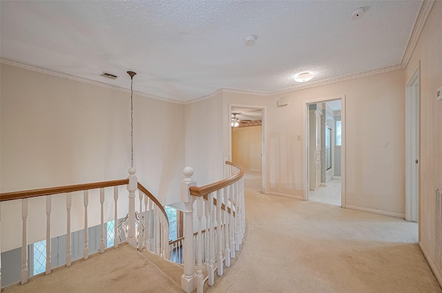 5318 Foresthaven Dr, Houston, TX 77066 - hallway with carpet floors, an upstairs landing, a textured ceiling, and ornamental molding
