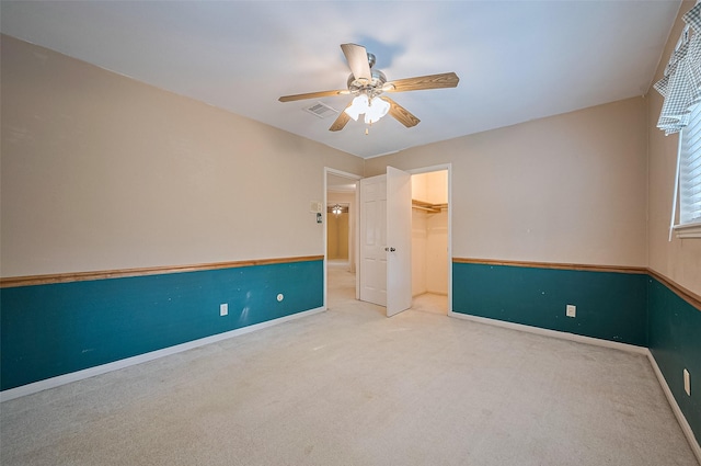 5318 Foresthaven Dr, Houston, TX 77066 - unfurnished bedroom featuring carpet flooring, a walk in closet, a closet, and a ceiling fan