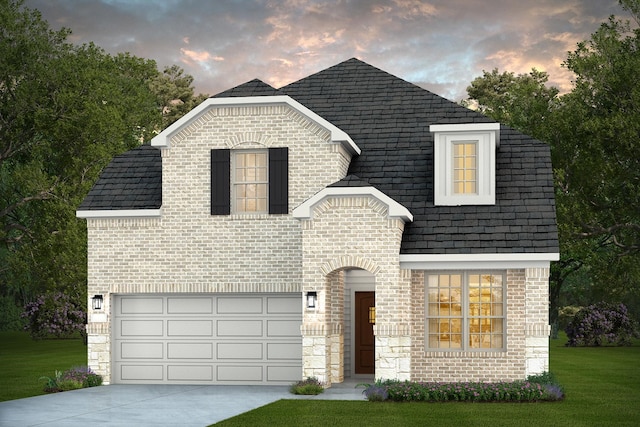 14577 Clementine Hall Dr, Conroe, TX 77378 - french country home with driveway, a front yard, and brick siding