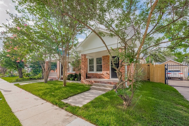 1026 W Cottage St, Houston, TX 77009 - view of front of property featuring a gate, brick siding, and a porch