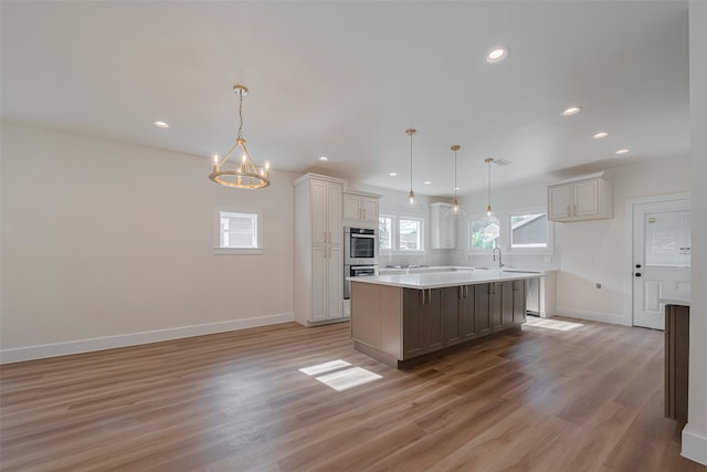 1026 W Cottage St, Houston, TX 77009 - kitchen with healthy amount of natural light, appliances with stainless steel finishes, light wood-style floors, light countertops, and recessed lighting