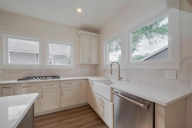 1026 W Cottage St, Houston, TX 77009 - kitchen with appliances with stainless steel finishes, decorative backsplash, light wood-style floors, light countertops, and recessed lighting
