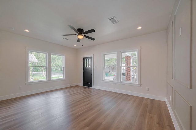 1026 W Cottage St, Houston, TX 77009 - unfurnished living room with light wood finished floors, a ceiling fan, and recessed lighting