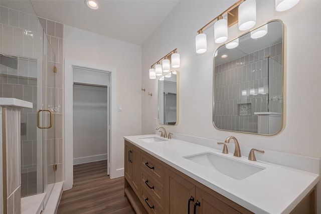 1026 W Cottage St, Houston, TX 77009 - bathroom with a stall shower, double vanity, wood finished floors, recessed lighting, and a walk in closet