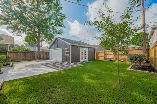 1026 W Cottage St, Houston, TX 77009 - fenced backyard with french doors, a garage, and an outbuilding