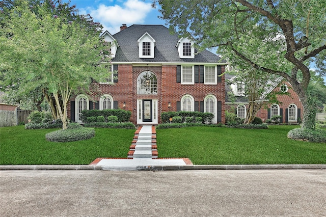 2206 Hickory Park Dr, Kingwood, TX 77345 - georgian-style home featuring brick siding, a chimney, and a shingled roof