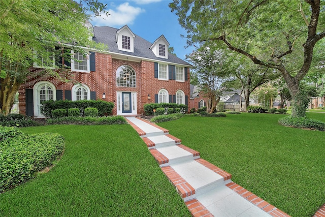 2206 Hickory Park Dr, Kingwood, TX 77345 - colonial inspired home featuring brick siding and a front lawn