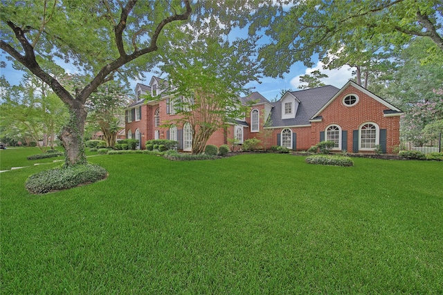 2206 Hickory Park Dr, Kingwood, TX 77345 - georgian-style home with a front yard and brick siding