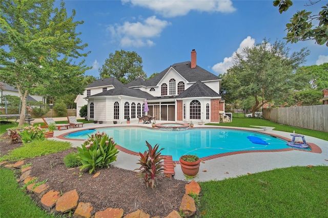 2206 Hickory Park Dr, Kingwood, TX 77345 - view of swimming pool featuring a patio and a pool with connected hot tub