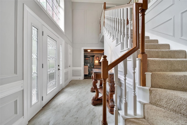 2206 Hickory Park Dr, Kingwood, TX 77345 - foyer featuring a decorative wall, stairway, and a high ceiling