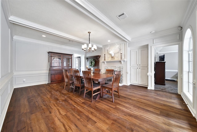2206 Hickory Park Dr, Kingwood, TX 77345 - dining space featuring plenty of natural light, a chandelier, dark wood-style floors, crown molding, and a textured ceiling