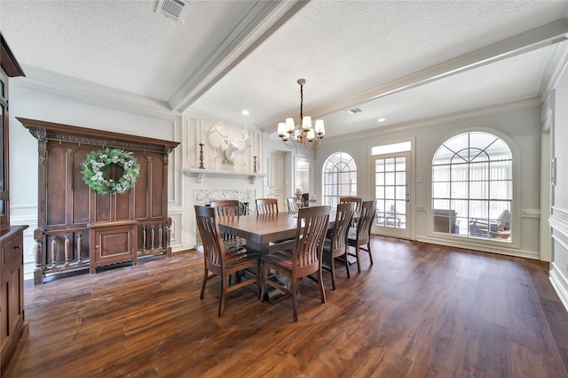 2206 Hickory Park Dr, Kingwood, TX 77345 - dining room featuring dark wood-type flooring, ornamental molding, a textured ceiling, a chandelier, and a decorative wall