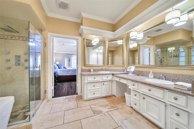 2206 Hickory Park Dr, Kingwood, TX 77345 - bathroom featuring double vanity, a shower stall, crown molding, and ensuite bath