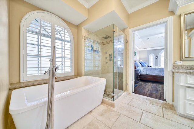 2206 Hickory Park Dr, Kingwood, TX 77345 - bathroom with a freestanding bath, a stall shower, vanity, ornamental molding, and ensuite bathroom