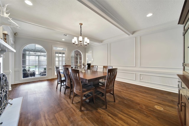 2206 Hickory Park Dr, Kingwood, TX 77345 - dining area with a decorative wall, ornamental molding, a chandelier, dark wood-type flooring, and a textured ceiling