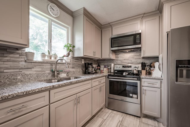 26752 Diamond Sq, Splendora, TX 77372 - kitchen featuring appliances with stainless steel finishes, decorative backsplash, and light stone counters