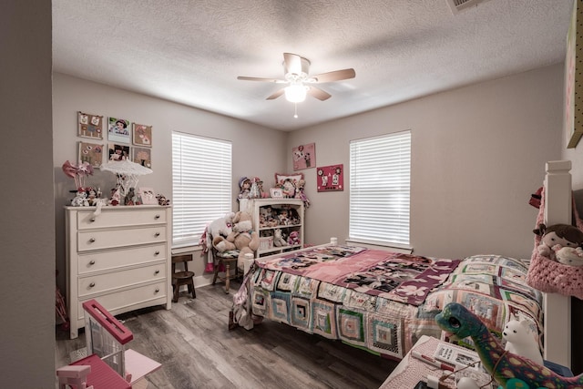 26752 Diamond Sq, Splendora, TX 77372 - bedroom featuring wood finished floors, a textured ceiling, and ceiling fan