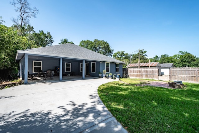 26752 Diamond Sq, Splendora, TX 77372 - back of property featuring roof with shingles, a patio area, and an outdoor structure