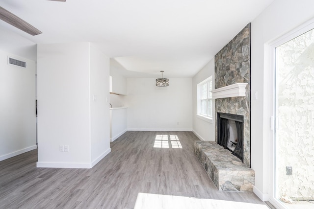 12239 Glenview Dr, Montgomery, TX 77356 - unfurnished living room with wood finished floors and a stone fireplace