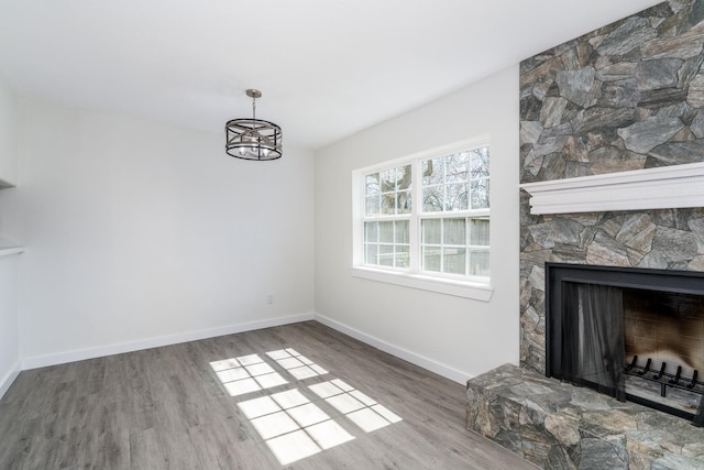 12239 Glenview Dr, Montgomery, TX 77356 - unfurnished living room with wood finished floors, a chandelier, and a fireplace