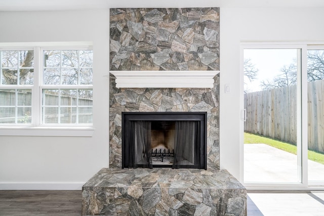 12239 Glenview Dr, Montgomery, TX 77356 - detailed view of wood finished floors and a fireplace with raised hearth