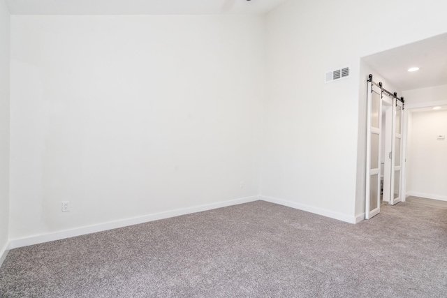 12239 Glenview Dr, Montgomery, TX 77356 - carpeted spare room with a barn door and recessed lighting
