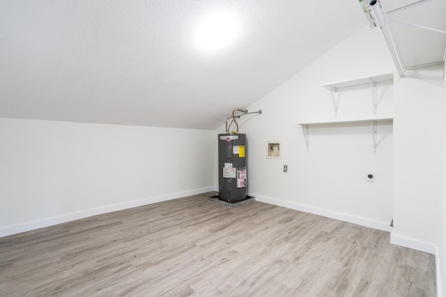 12239 Glenview Dr, Montgomery, TX 77356 - bonus room with water heater, lofted ceiling, and light wood finished floors