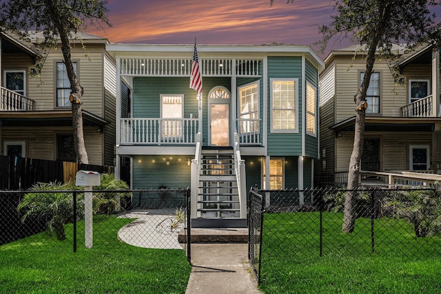 3515 Winnie St, Galveston, TX 77550 - view of front facade featuring a porch, stairs, and a fenced front yard