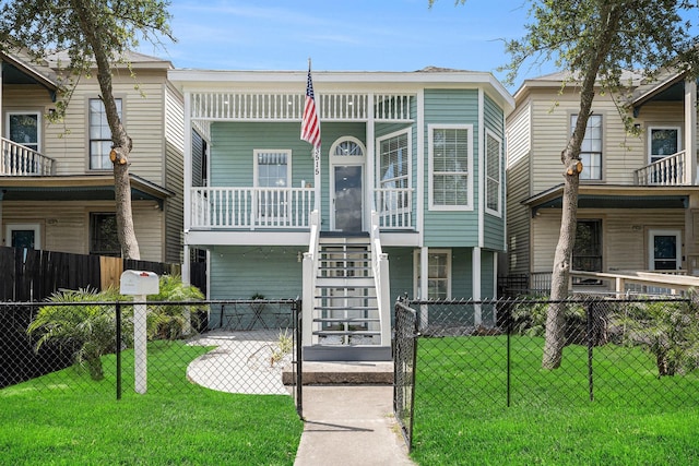 3515 Winnie St, Galveston, TX 77550 - view of building exterior featuring stairway and a fenced front yard