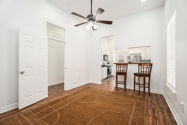 3515 Winnie St, Galveston, TX 77550 - spare room featuring dark wood finished floors, a ceiling fan, and high vaulted ceiling