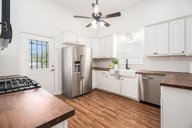 3515 Winnie St, Galveston, TX 77550 - kitchen with appliances with stainless steel finishes, ceiling fan, tasteful backsplash, white cabinets, and high vaulted ceiling